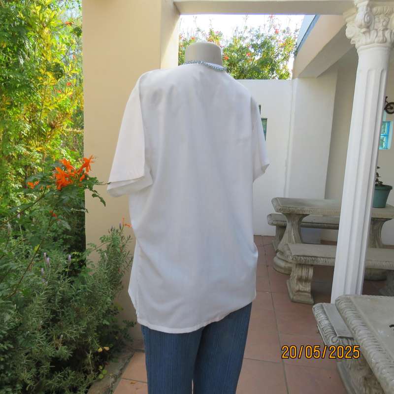 Unique boutique made white V neck short sleeve top. Blue print on front. Size 40