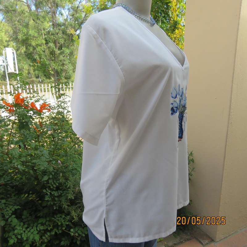 Unique boutique made white V neck short sleeve top. Blue print on front. Size 40