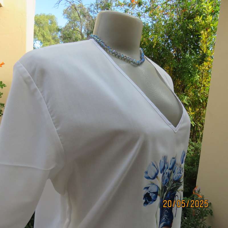 Unique boutique made white V neck short sleeve top. Blue print on front. Size 40