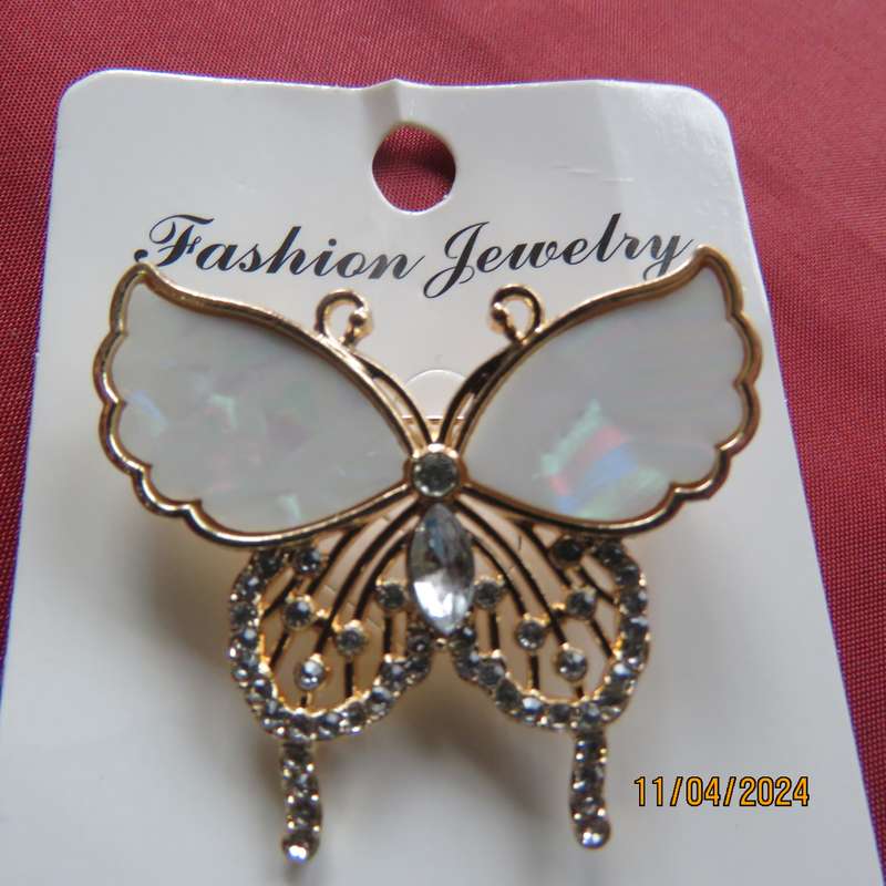 Butterfly brooch on gold colour with beautiful white shiny wings and tiny faux diamonds. New item.