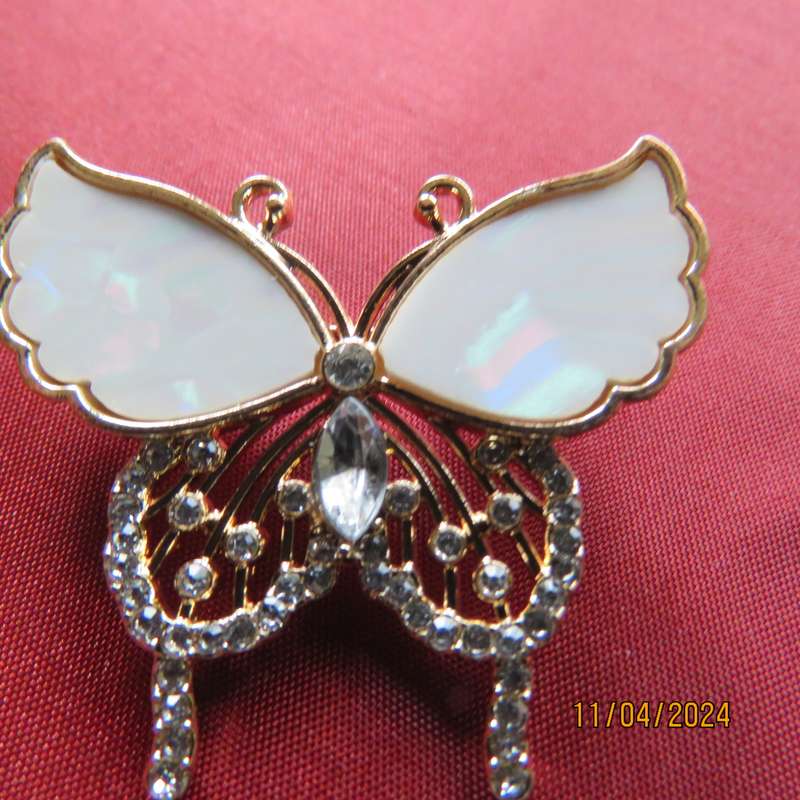 Butterfly brooch on gold colour with beautiful white shiny wings and tiny faux diamonds. New item.