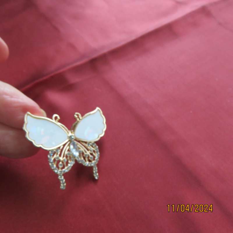 Butterfly brooch on gold colour with beautiful white shiny wings and tiny faux diamonds. New item.