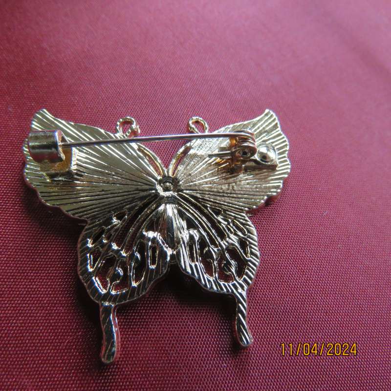 Butterfly brooch on gold colour with beautiful white shiny wings and tiny faux diamonds. New item.