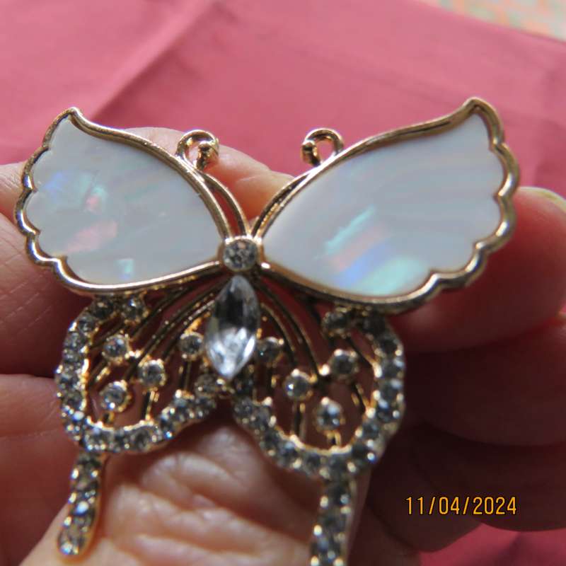 Butterfly brooch on gold colour with beautiful white shiny wings and tiny faux diamonds. New item.