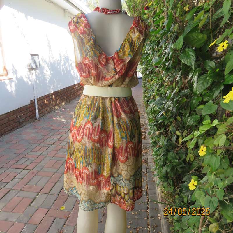 Cool colourful sleeveless dress with frilled V neckline. Size 37. Lined. Elasticated waist.