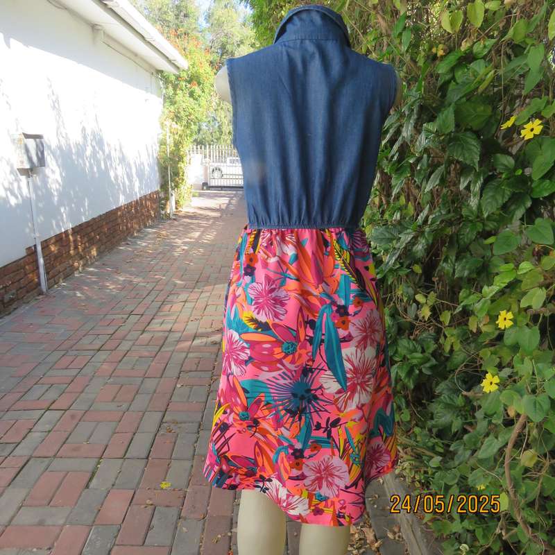 Casual dress with blue denim top and bright floral polyester high-low skirt. Size 34