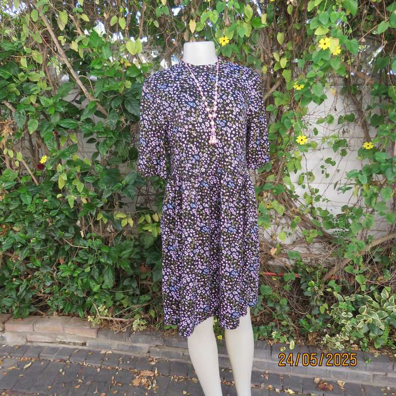 Soft easy to wear black stretch viscose empire dress with mini pink-blue flowers. Size 34