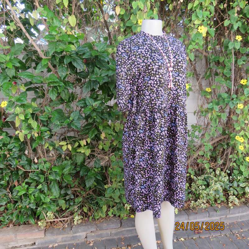 Soft easy to wear black stretch viscose empire dress with mini pink-blue flowers. Size 34