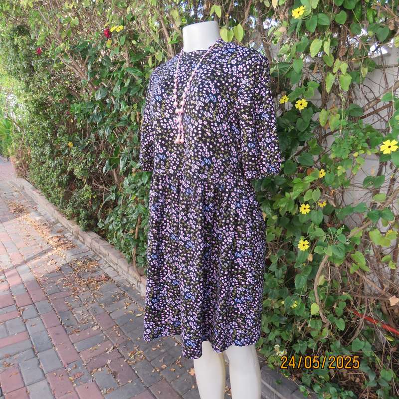 Soft easy to wear black stretch viscose empire dress with mini pink-blue flowers. Size 34