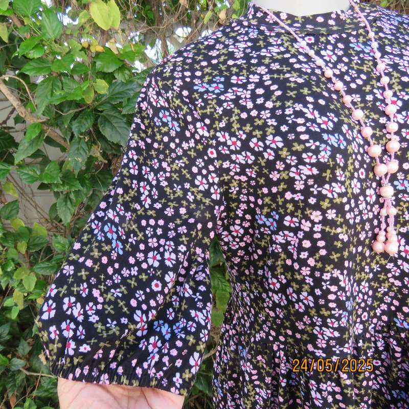 Soft easy to wear black stretch viscose empire dress with mini pink-blue flowers. Size 34