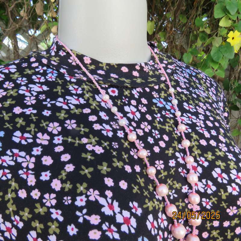 Soft easy to wear black stretch viscose empire dress with mini pink-blue flowers. Size 34