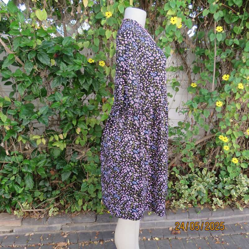 Soft easy to wear black stretch viscose empire dress with mini pink-blue flowers. Size 34