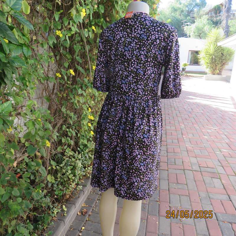 Soft easy to wear black stretch viscose empire dress with mini pink-blue flowers. Size 34
