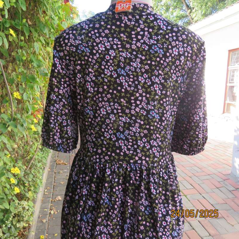 Soft easy to wear black stretch viscose empire dress with mini pink-blue flowers. Size 34