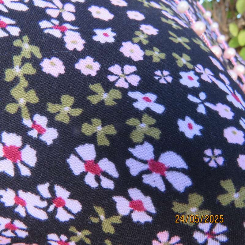 Soft easy to wear black stretch viscose empire dress with mini pink-blue flowers. Size 34