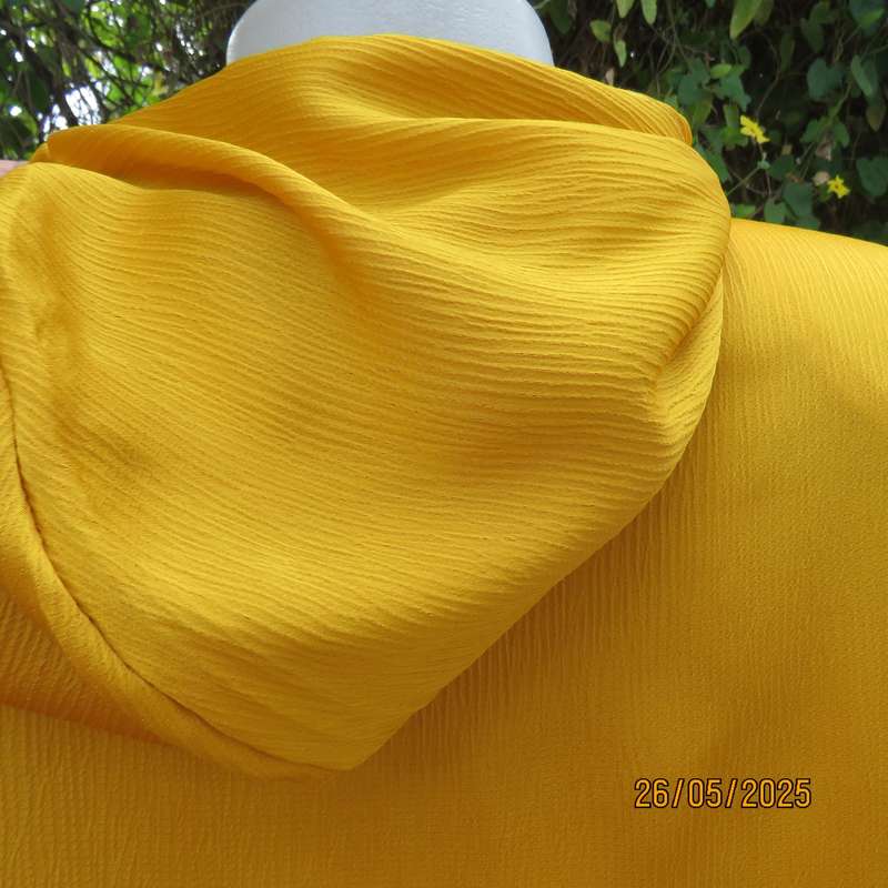 Hooded IQ luxury textured polyester long sleeve top. Short zip-up front opening. Size 42