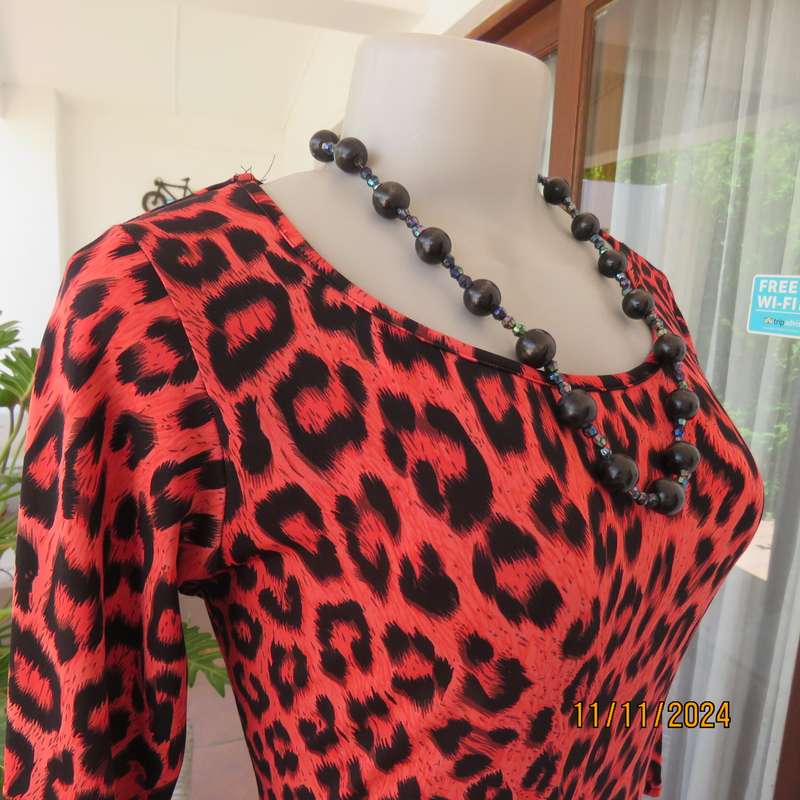 AQARA  pretty red and black animal print peplum style slip over top. Size 32. As new.