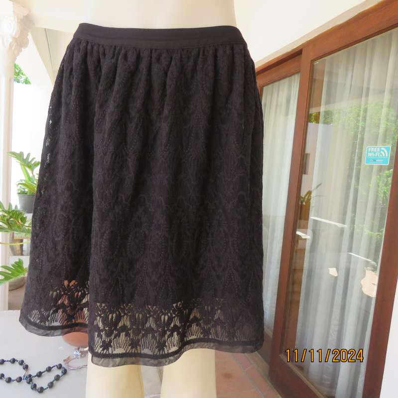 Very black knee length acrylic lace skirt. Stretch poly lining. By`FREE 2BU` in size 35-11 As new.