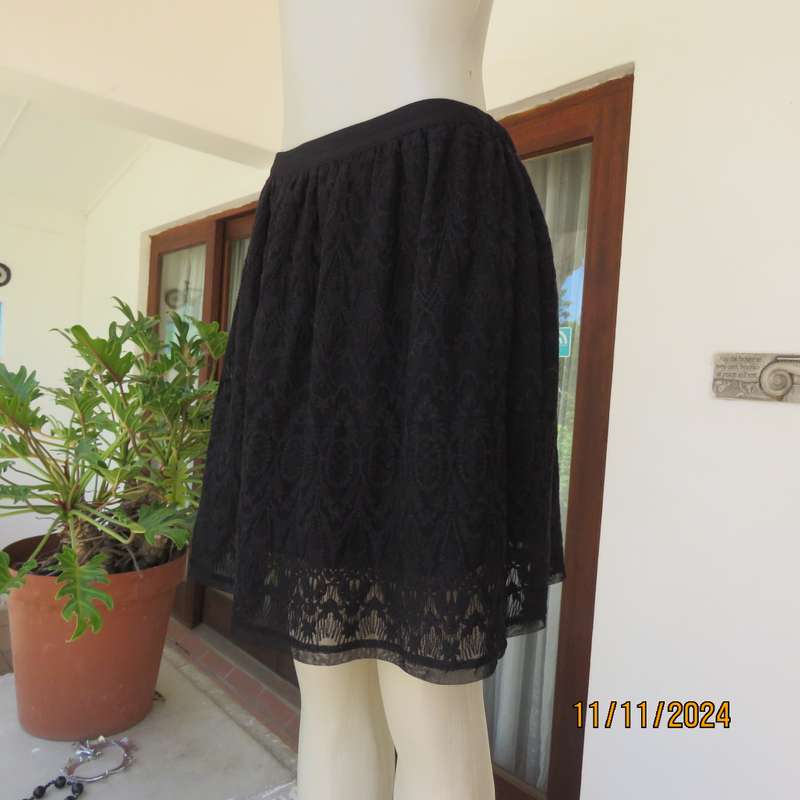 Very black knee length acrylic lace skirt. Stretch poly lining. By`FREE 2BU` in size 35-11 As new.