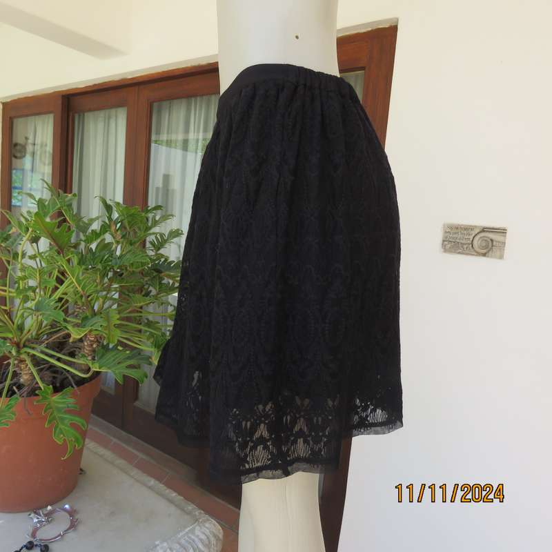 Very black knee length acrylic lace skirt. Stretch poly lining. By`FREE 2BU` in size 35-11 As new.