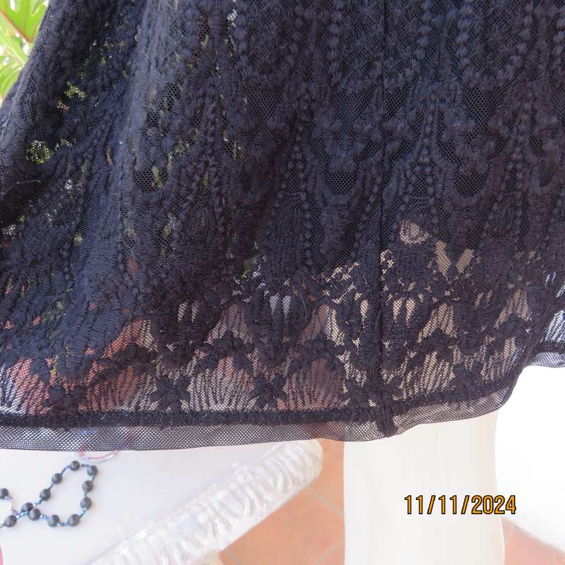 Very black knee length acrylic lace skirt. Stretch poly lining. By`FREE 2BU` in size 35-11 As new.