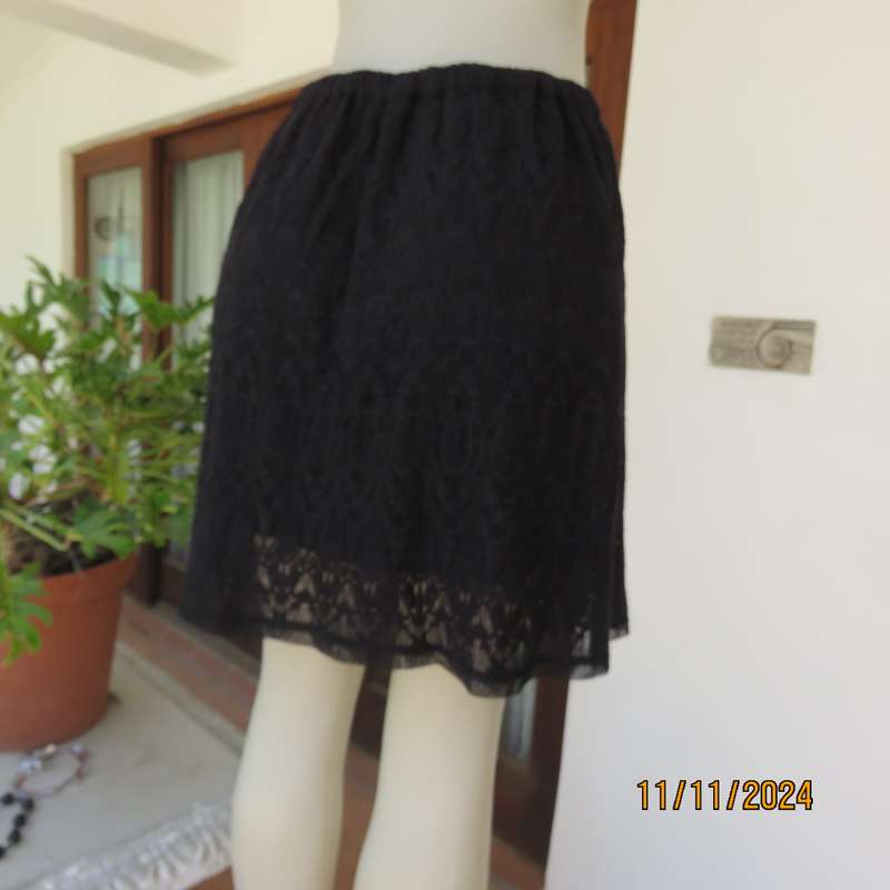 Very black knee length acrylic lace skirt. Stretch poly lining. By`FREE 2BU` in size 35-11 As new.
