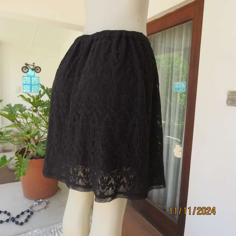 Very black knee length acrylic lace skirt. Stretch poly lining. By`FREE 2BU` in size 35-11 As new.