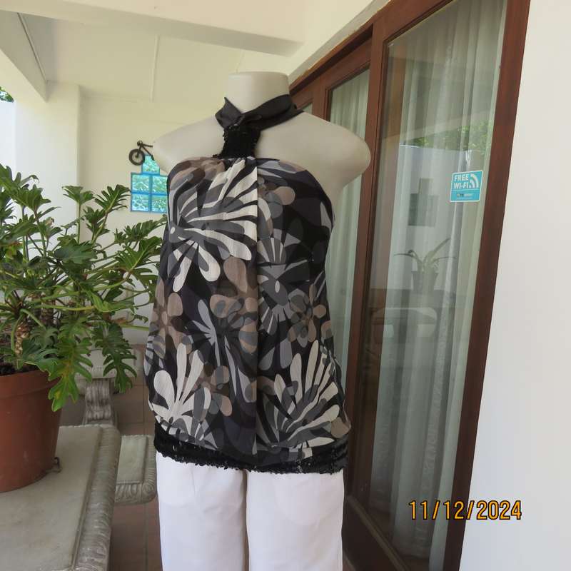 Smart halter neck top by ZIXA size 38 in black-grey-white floral poly-georgette. Black sequin band.