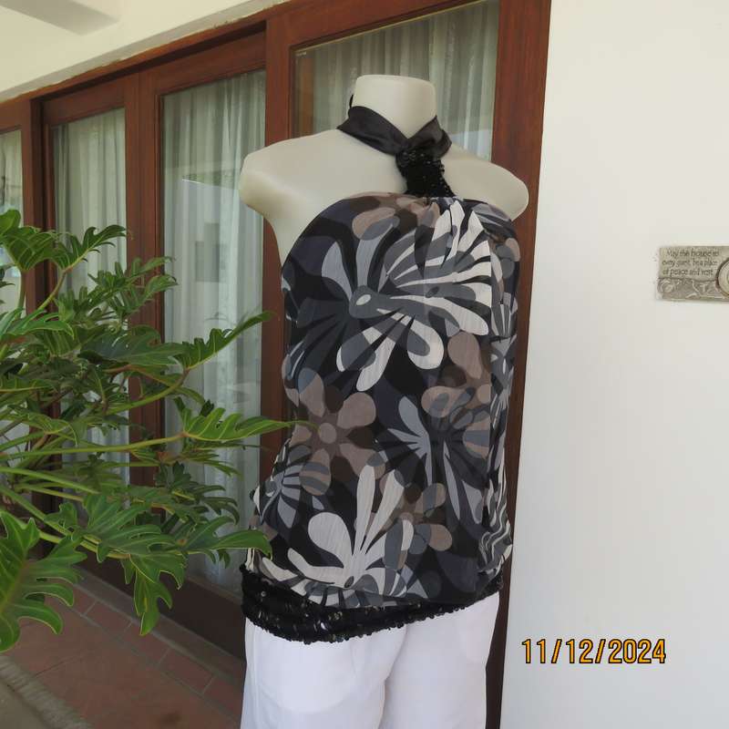 Smart halter neck top by ZIXA size 38 in black-grey-white floral poly-georgette. Black sequin band.