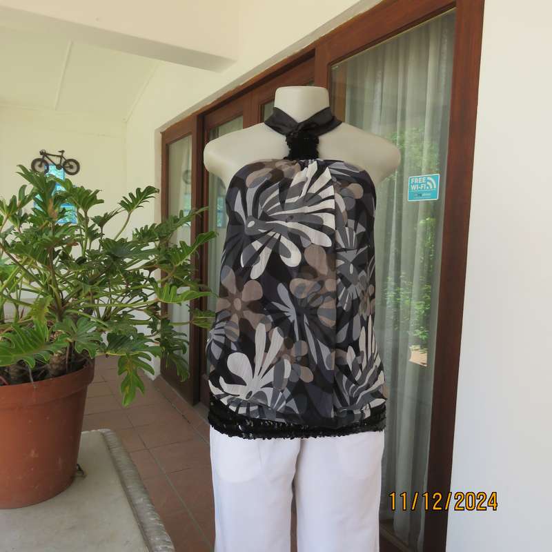 Smart halter neck top by ZIXA size 38 in black-grey-white floral poly-georgette. Black sequin band.