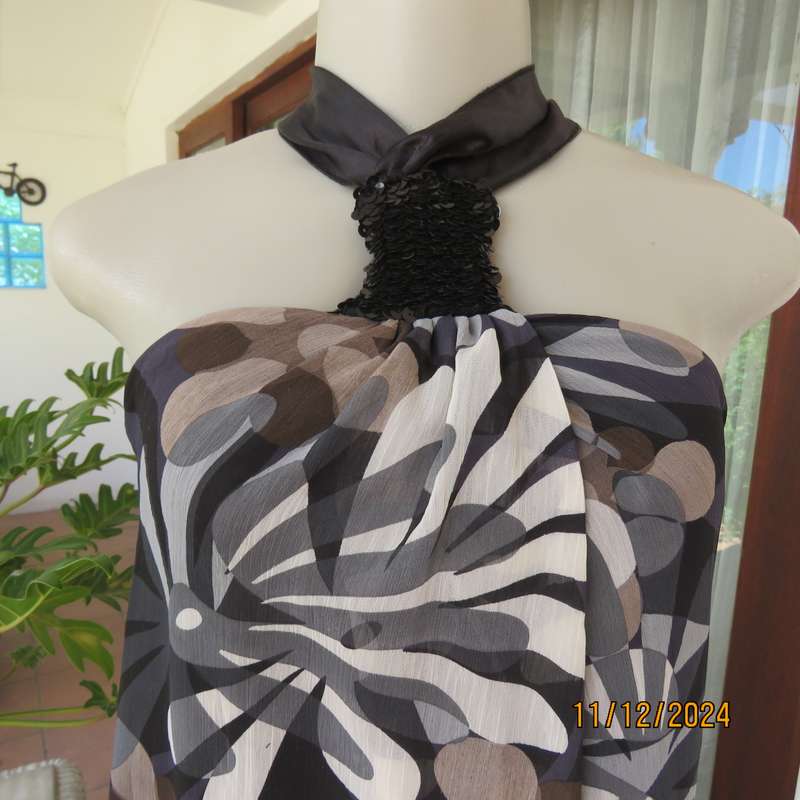 Smart halter neck top by ZIXA size 38 in black-grey-white floral poly-georgette. Black sequin band.
