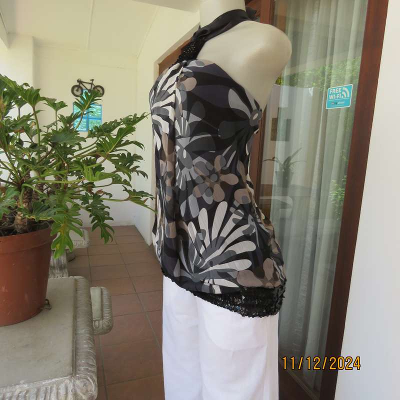 Smart halter neck top by ZIXA size 38 in black-grey-white floral poly-georgette. Black sequin band.