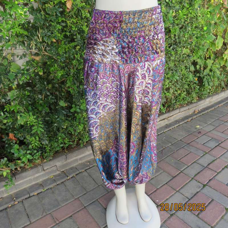 Harem pants in jewel colours with peacock feather patterns. Silky poly-rayon. Size 34-36.