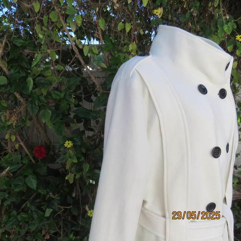 Light cream warm 100% polyester fully lined double breast jacket with belt. Size 44-46