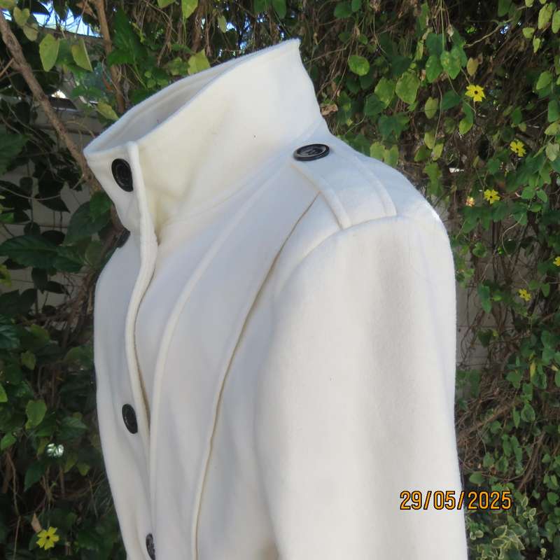 Light cream warm 100% polyester fully lined double breast jacket with belt. Size 44-46