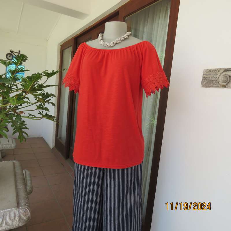 Eye catching bright red slip over polyester top. Short sleeves. Wide elasticated neckline.Size 36.