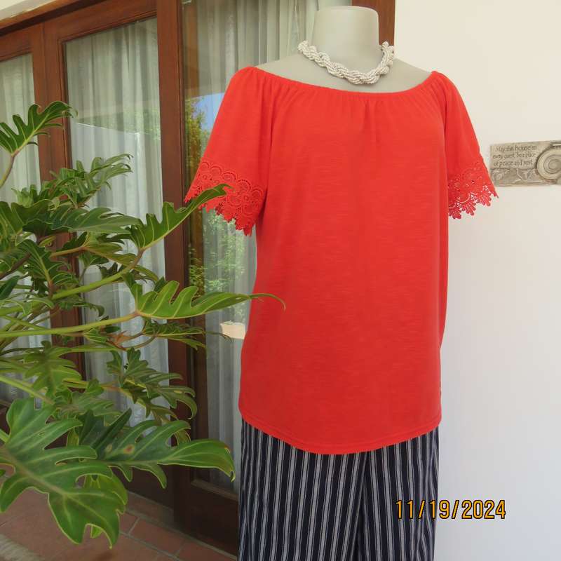 Eye catching bright red slip over polyester top. Short sleeves. Wide elasticated neckline.Size 36.