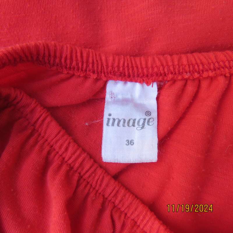 Eye catching bright red slip over polyester top. Short sleeves. Wide elasticated neckline.Size 36.