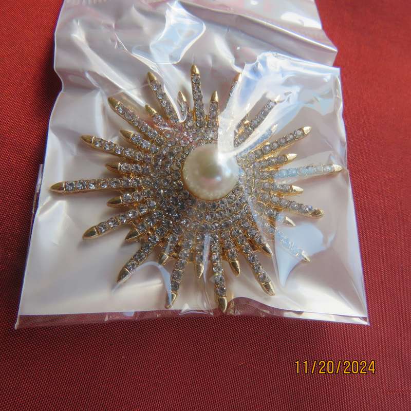 Unique shiny delicate brooch with lots of simulated diamonds on gold. Faux pearl in center.New item