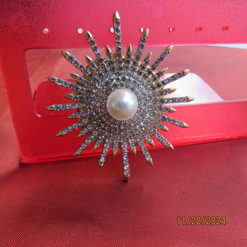 Unique shiny delicate brooch with lots of simulated diamonds on gold. Faux pearl in center.New item