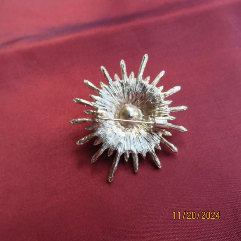Unique shiny delicate brooch with lots of simulated diamonds on gold. Faux pearl in center.New item