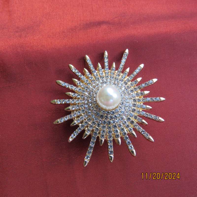 Unique shiny delicate brooch with lots of simulated diamonds on gold. Faux pearl in center.New item