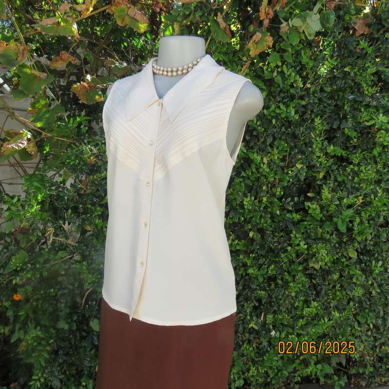 FEMININE sleeveless rich cream blouse from Tokyo in size 34. Dainty double collar.