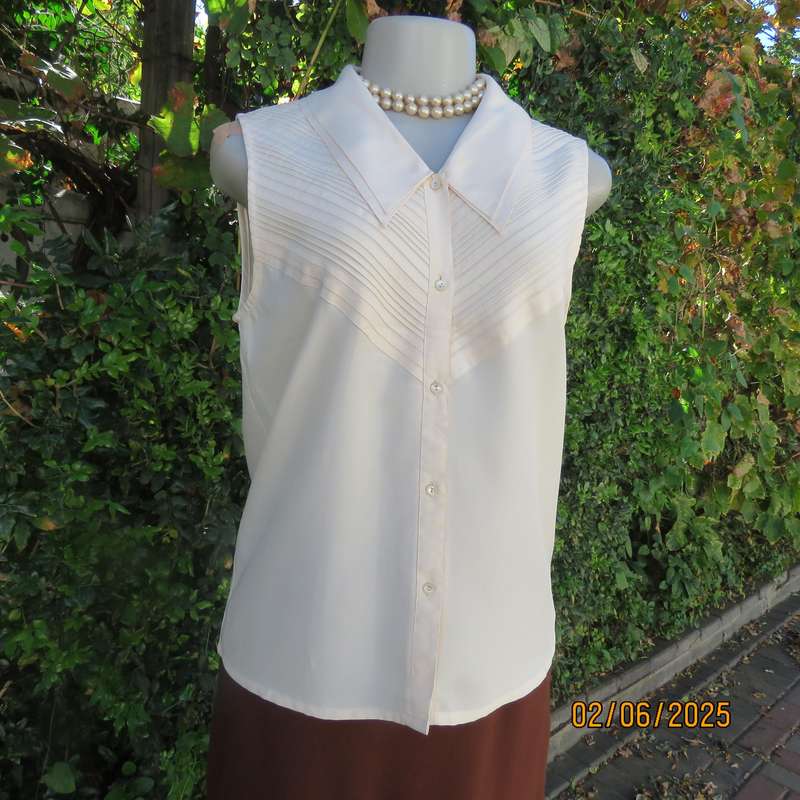 FEMININE sleeveless rich cream blouse from Tokyo in size 34. Dainty double collar.