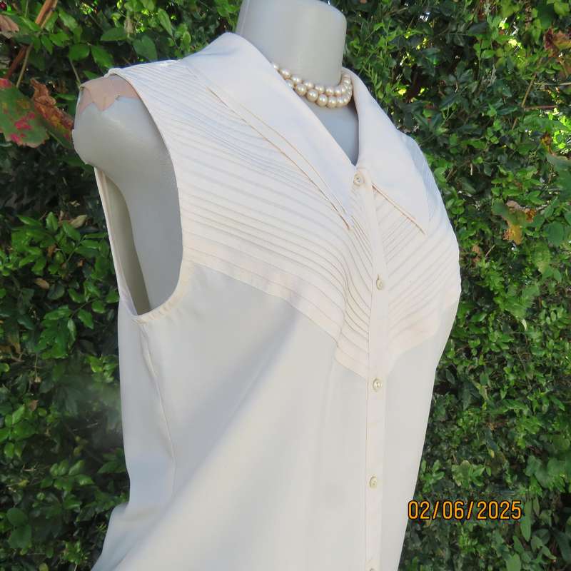 FEMININE sleeveless rich cream blouse from Tokyo in size 34. Dainty double collar.