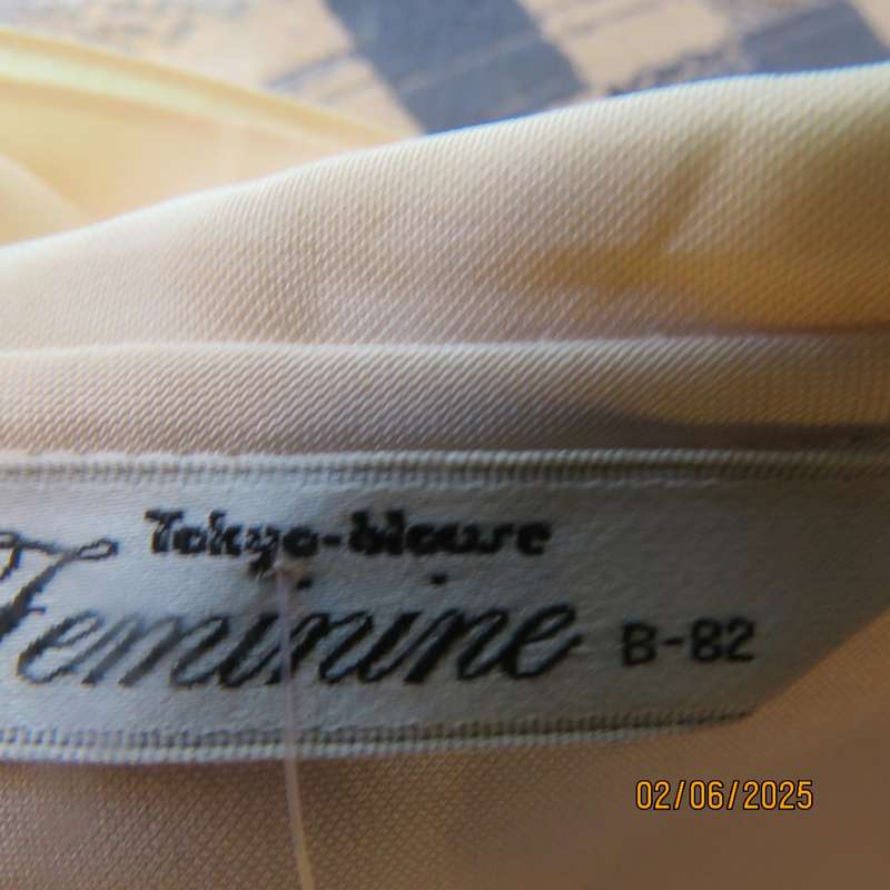 FEMININE sleeveless rich cream blouse from Tokyo in size 34. Dainty double collar.