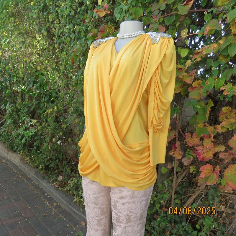 Buttercup yellow unique size 40 stretch polyester top. Crossover overlays. Shoulder decoration.