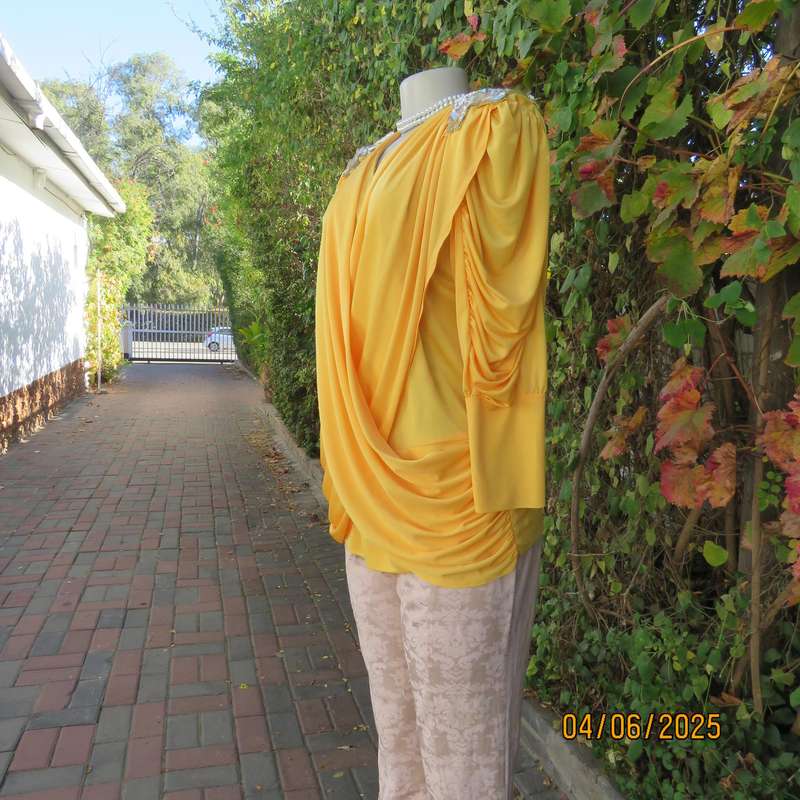 Buttercup yellow unique size 40 stretch polyester top. Crossover overlays. Shoulder decoration.