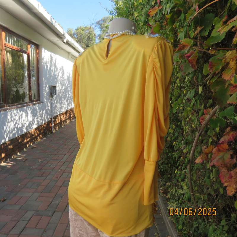 Buttercup yellow unique size 40 stretch polyester top. Crossover overlays. Shoulder decoration.