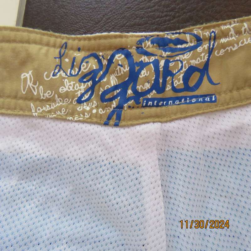 LIZZARD, as new men's white boardshorts. Golden brown-blue logo and stripes.Size 34 Breathing fabric